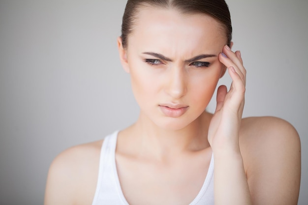 health and head pain beautiful woman having strong headache feeling pain
