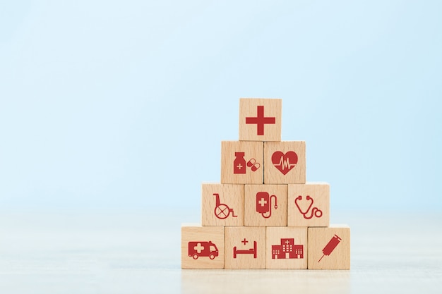 Health Insurance Concept,arranging wood block stacking with icon healthcare medical.