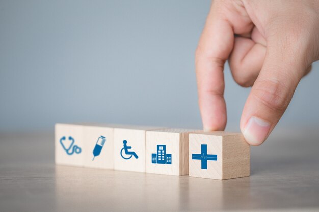 health insurance concept,arranging wood block stacking with icon healthcare medical.