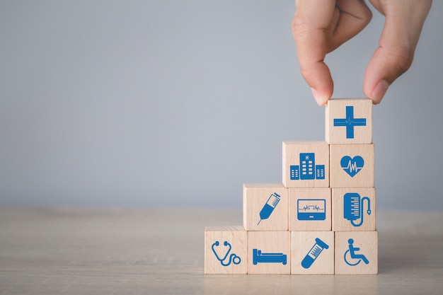 Health Insurance Concept,hand arranging wood block stacking with icon healthcare medical.