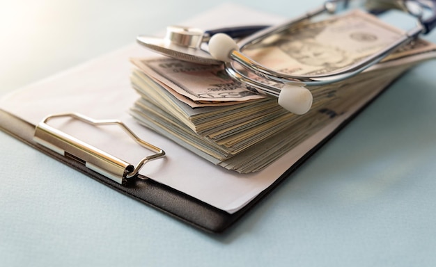 Health insurance concept stethoscope over the money