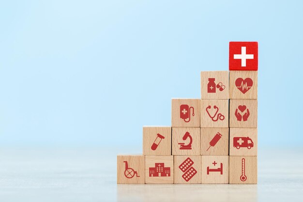 Health insurance concepthand arranging wood block stacking with icon healthcare medical