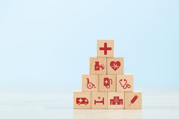 Health insurance concepthand arranging wood block stacking with icon healthcare medical