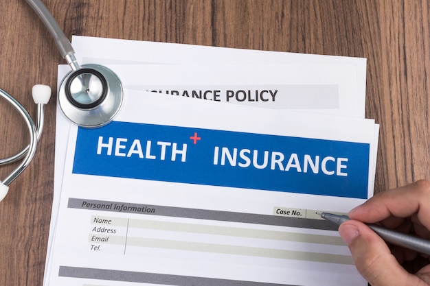 Photo health insurance form in man hand