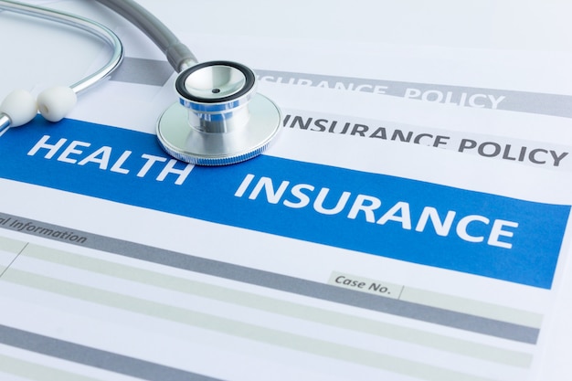 Photo health insurance form with stethoscope in top view