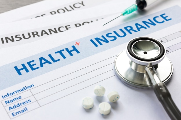 Photo health insurance form with stethoscope