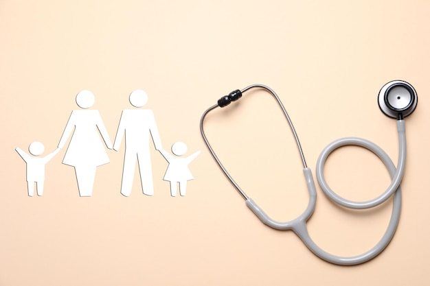 Health insurance Stethoscope and illustration of family on beige background top view