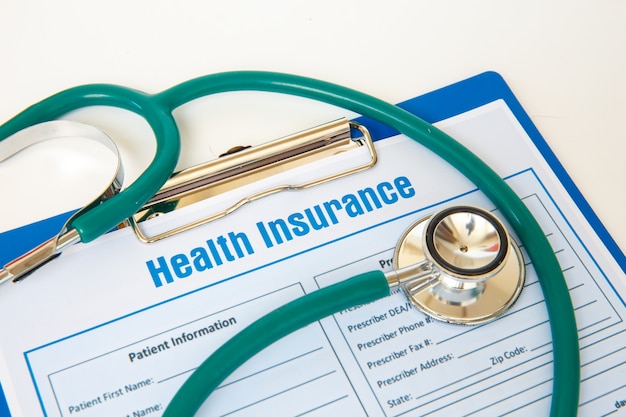 Photo health insurance with insurance claim form and stethoscope