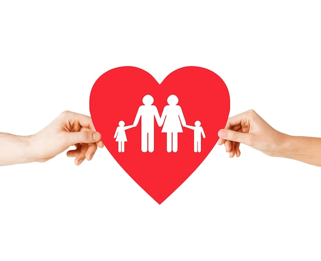 health, love, adoption and relationships concept - closeup of couple hands with big red heart with family and kids