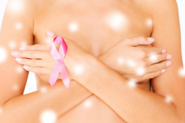 health, medicine, beauty concept - naked woman with breast cancer awareness ribbon