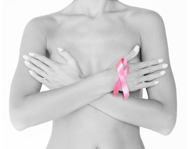 health and medicine concept - naked woman with breast cancer awareness ribbon