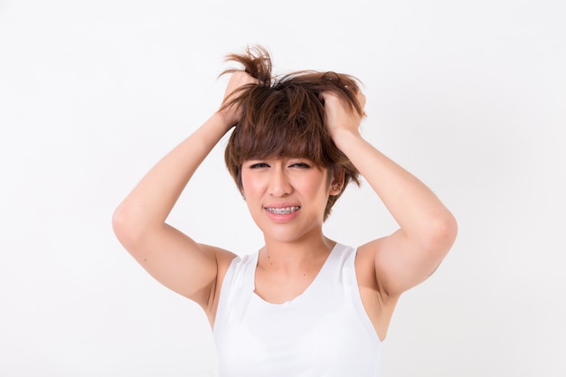 Health and pain. Stressed exhausted young woman having strong tension headache.  Isolated on white b