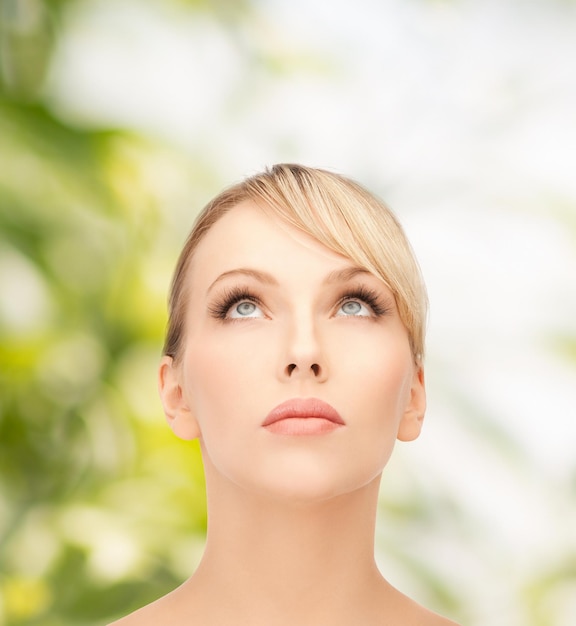 health, spa and beauty concept - beautiful woman with blonde hair looking up