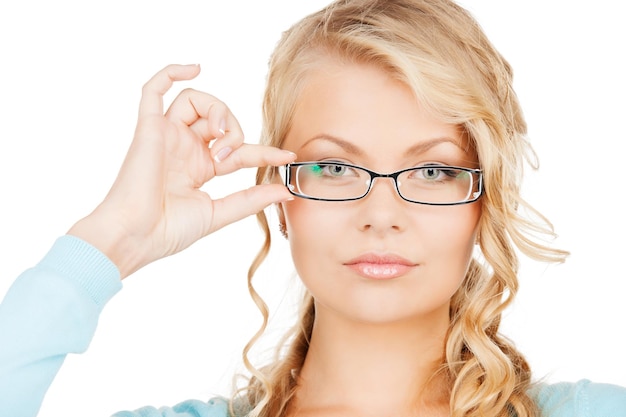 health and vision concept - close up of beautiful young woman wearing eyeglasses