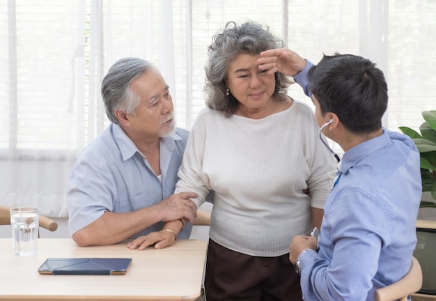 Health visitor and senior woman during home visit.