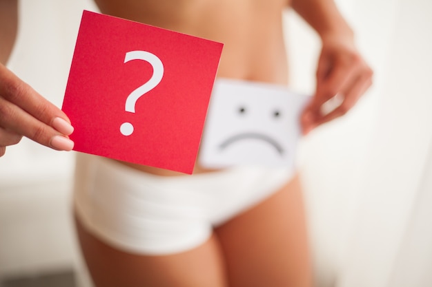 Health. Woman Body In Underwear With Question Card Near Belly