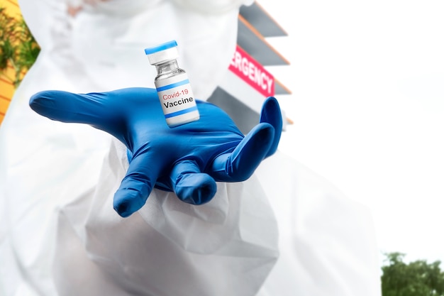 Health worker hand with gloves holding covid 19 vaccines on the hospital