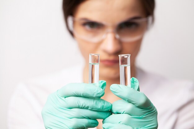 Photo health worker holds a test tube with a test of covid-2019