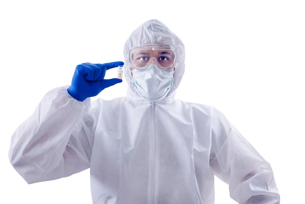 Health worker man with a protective suit and gloves holding covid 19 vaccines isolated over white background