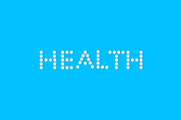Здоровье, написанное таблетками на синем