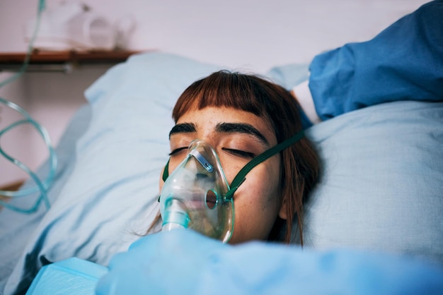 Healthcare anesthesia and woman with an oxygen mask recovery and operation in hospital bed Female lady and patients with breathing equipment coma and cardiology with emergency and ventilation