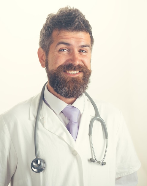 Healthcare clinic treatment and medical concept friendly cheerful bearded physician with stethoscope