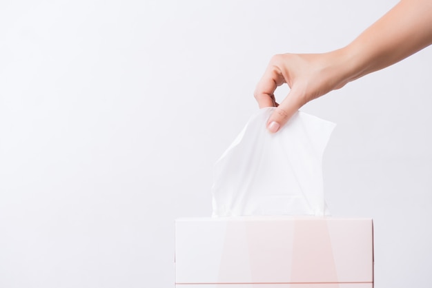 Healthcare concept. Woman hand picking white tissue paper from box.