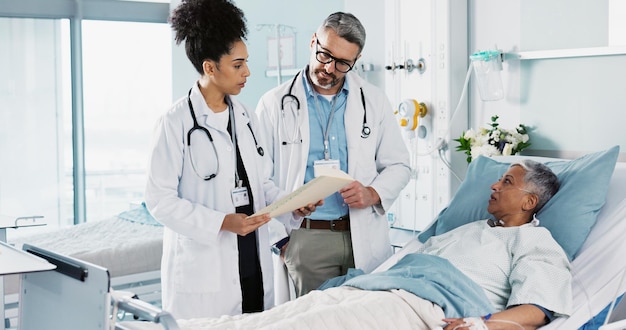 Healthcare documents and a medical team of doctors checking on a patient in recovery or rehabilitation Medicine teamwork and explain with a group of health professionals in a hospital for wellness