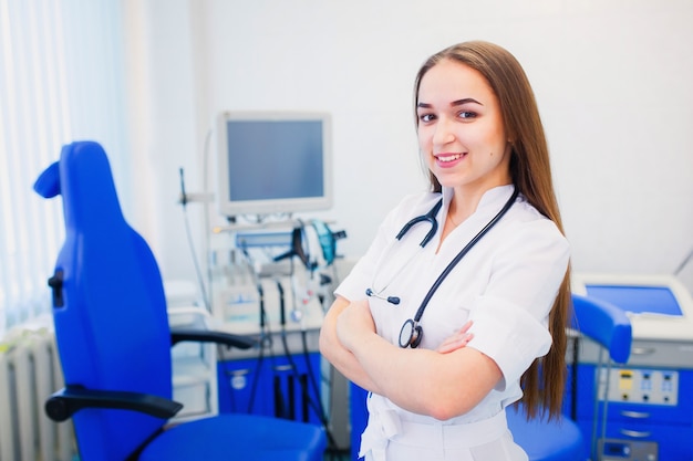 Healthcare and health. ENT. young doctor is an otolaryngologist with arms crossed in a modern office. The pediatrician invites to the examination