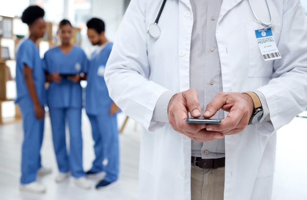 Healthcare hospital and hands of doctor with phone for research telehealth and medical consulting Nurse team clinic and health worker on smartphone for patient data wellness app and internet