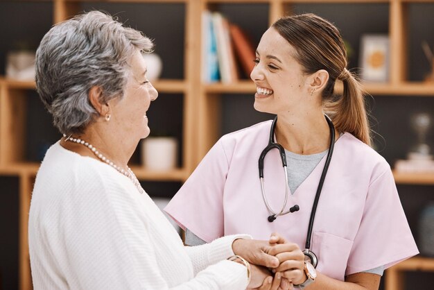 Photo healthcare insurance and a senior woman patient and nurse consulting during a checkup in a retirement home medical support and wellness with a medicine professional talking to a mature female