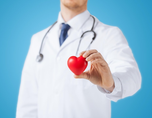 healthcare and medical concept - male doctor with heart