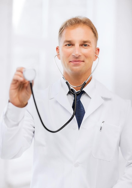 healthcare and medical concept - young male doctor with stethoscope