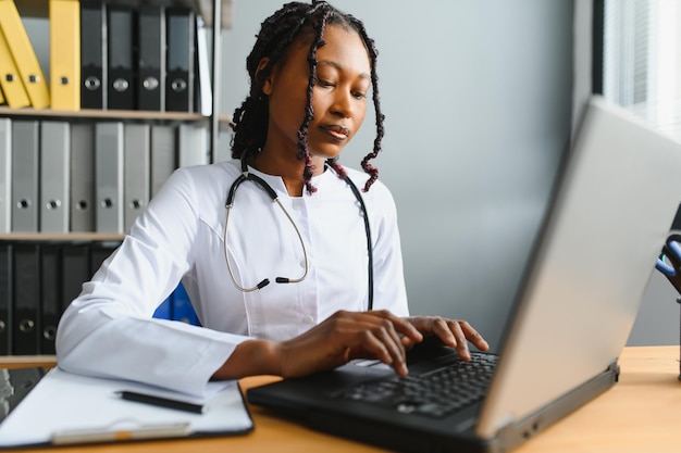 Healthcare medical and technology concept african female doctor with laptop