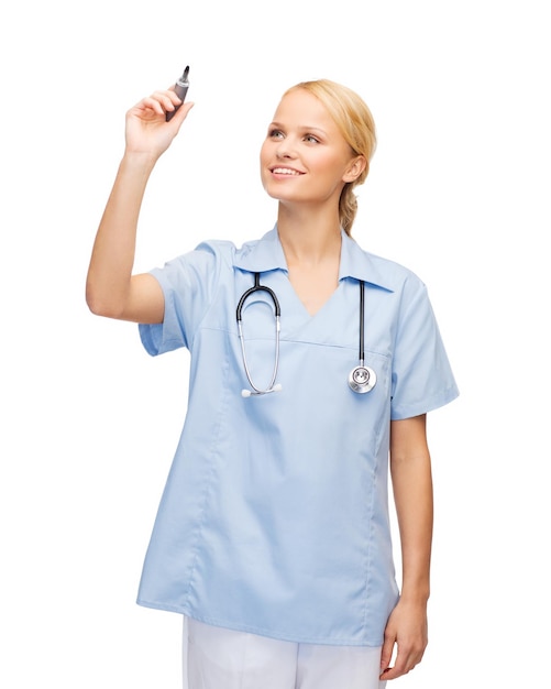 healthcare, medical and technology - young doctor or nurse writing something in the air