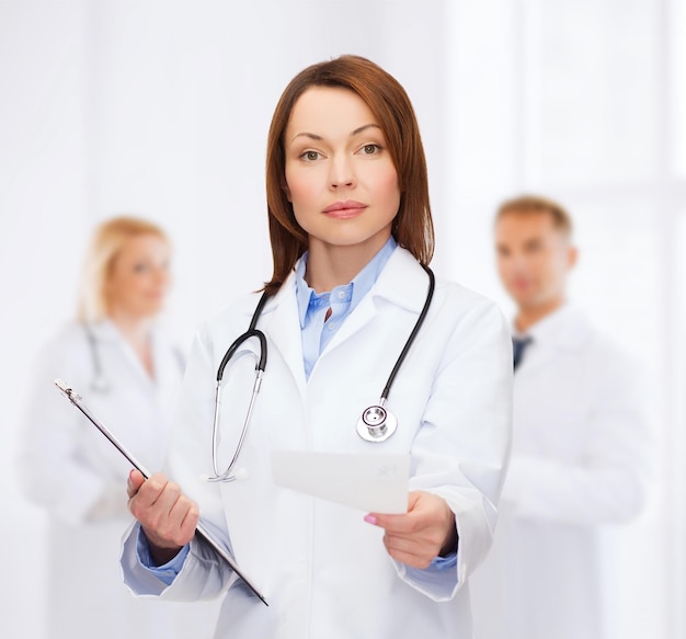 healthcare and medicine concept - calm female doctor with clipboard and stethoscope