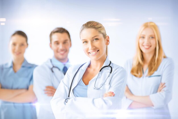 healthcare and medicine concept - female doctor in front of medical group