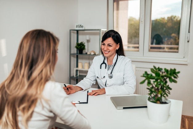 Healthcare and medicine concept. Friendly female doctor in conversation with female patient.