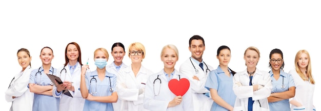 healthcare and medicine concept - smiling doctors and nurses with red heart