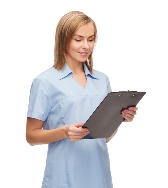 healthcare and medicine concept - smiling female doctor or nurse with clipboard