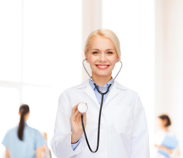 healthcare and medicine concept - smiling female doctor with stethoscope