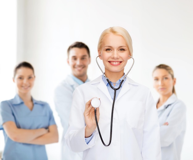 healthcare and medicine concept - smiling female doctor with stethoscope