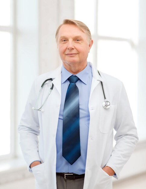 healthcare and medicine concept - smiling standing doctor or professor with stethoscope