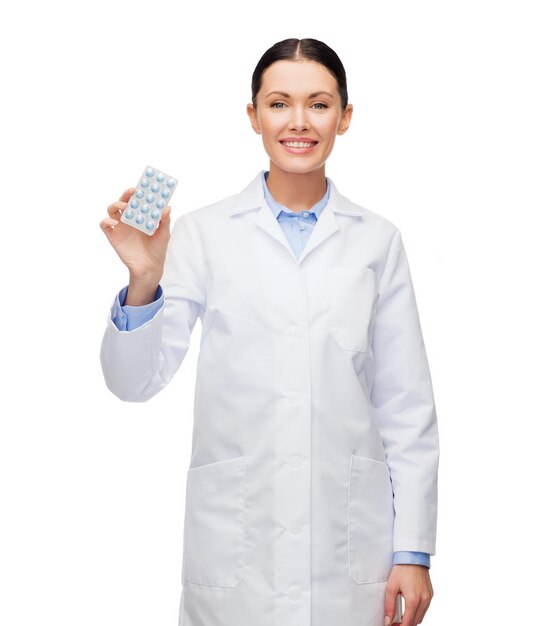 healthcare, medicine and pharmacy concept - smiling female doctor and with pills