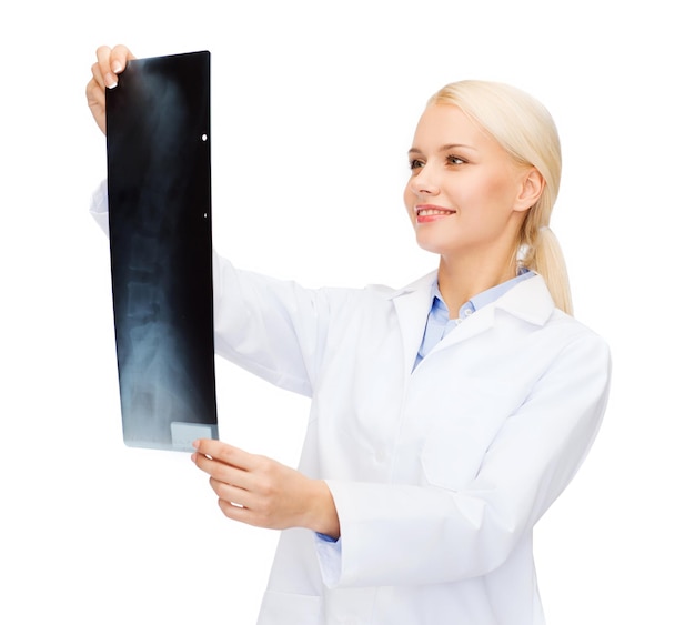 healthcare, medicine and radiology concept - smiling female doctor looking at x-ray