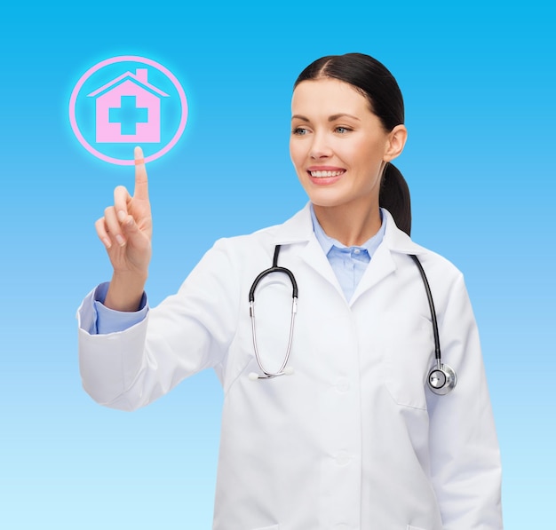 의료, 의학 및 기술 개념 - 병원 표지판을 가리키는 웃는 여성 의사