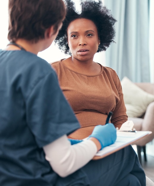 healthcare nurse and pregnant woman during a consultation planning support and medical paperwork strategy insurance and african patient talking to a doctor about health update during pregnancy