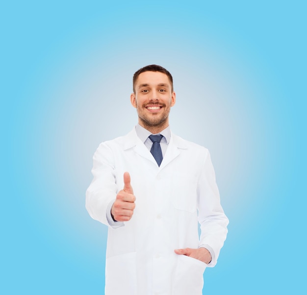 healthcare, profession and medicine concept - smiling male doctor showing thumbs up over white background