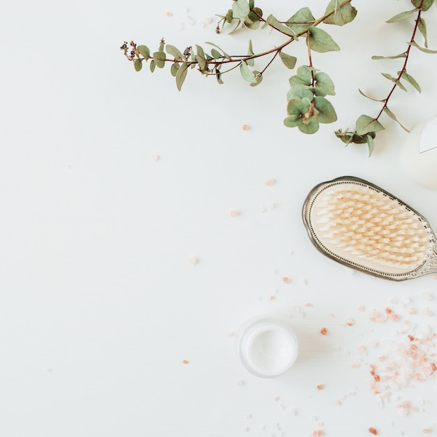 Healthcare spa concept with copy space mock up with eucalyptus, hairbrush, cream on white