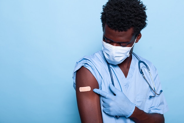 Healthcare specialist having adhesive bandage after vaccination